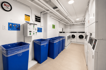New York apartment for rent - A laundry room with washers and dryers and blue bins.