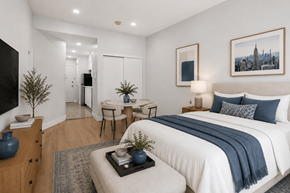 New York triplex for rent - A bedroom with a large bed and a small table with a plant on it.