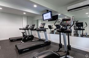 Wallingford apartment for rent - A gym with treadmills and a television mounted on the wall.