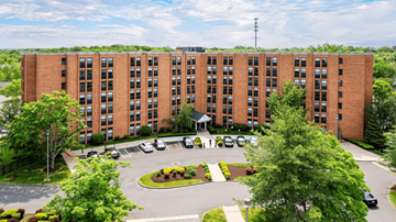New Britain apartment for rent - A large red brick building with a circular driveway in front.