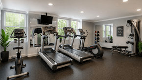 New Britain apartment for rent - A spacious home gym with treadmills, elliptical machines, and other exercise equipment.