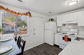 Indianapolis townhouse for rent - A kitchen with white appliances and a table with plates on it.