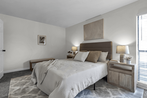 Columbus townhouse for rent - A bedroom with a large bed and a wooden headboard.