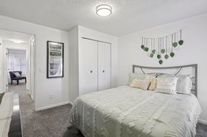 Indianapolis townhouse for rent - A bedroom with a bed, a chair, and a framed picture on the wall.