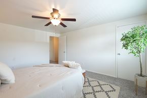 Columbus townhouse for rent - A bedroom with a large bed and a ceiling fan.