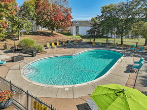 Pontiac apartment for rent - A green umbrella is open next to a swimming pool.
