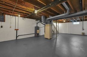 Columbus townhouse for rent - A spacious basement with a concrete floor and a staircase leading to the upper level.