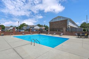 Columbus townhouse for rent - A large swimming pool with a metal ladder in the middle of it.