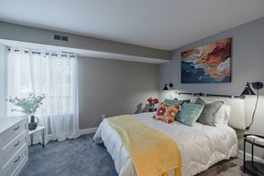 Pontiac apartment for rent - a bedroom with a bed and a painting on the wall