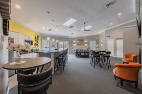 Pontiac apartment for rent - a clubhouse with a dining area and a bar with chairs and tables