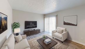 Columbus townhouse for rent - A living room with a couch, chair, and television.