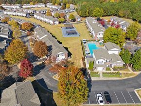 Jonesboro townhouse for rent - A bird's eye view of a residential area with houses, trees, and a swimming pool.