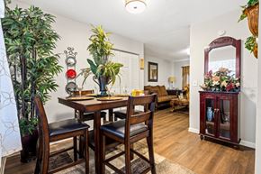 Newnan apartment for rent - A dining room with a wooden table and chairs.