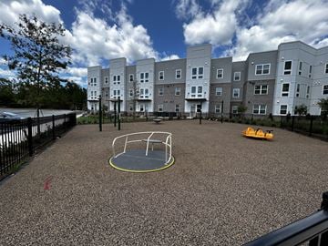 Centerville apartment for rent - A playground with a yellow circle in the middle of a grey surface.