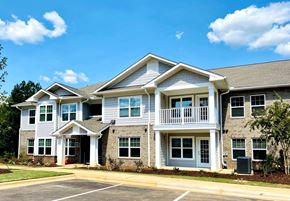Lancaster apartment for rent - A two-story building with a parking lot in front.