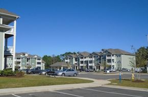 Southport apartment for rent - an empty parking lot in front of an apartment building
