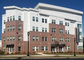 Atlanta apartment for rent - A large brick building with a white section on the top floor.