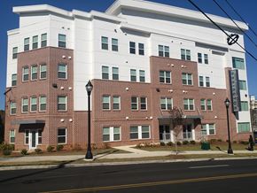 Atlanta apartment for rent - A large white and red building with a street in front.