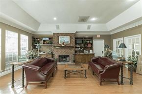 Greer apartment for rent - A living room with a fireplace and two brown leather chairs.