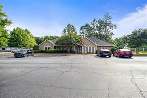 Greer apartment for rent - A parking lot with a building and cars in front.