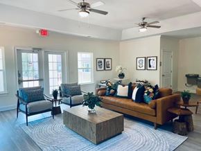 Lancaster apartment for rent - A living room with a brown couch, two chairs, and a coffee table.