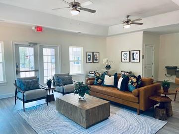 Lancaster apartment for rent - A living room with a brown couch, two chairs, and a coffee table.