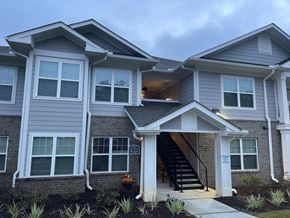 Lancaster apartment for rent - A modern two-story house with a front porch and stairs leading to the entrance.