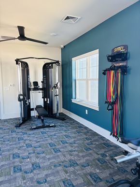 Raleigh apartment for rent - A home gym with a blue wall and a window.
