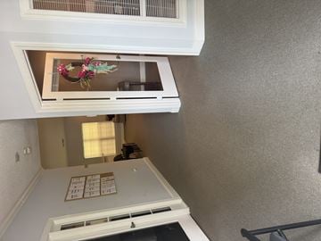 Jacksonville apartment for rent - A white kitchen with a wreath on the window.