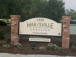 Hartsville apartment for rent - A sign for Hartsville Crossing with a phone number and office number.