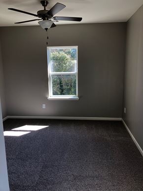 Elberton apartment for rent - A room with a ceiling fan and a window.