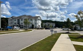 Raleigh apartment for rent - A residential area with apartment buildings and cars parked on the street.
