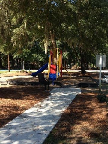Ridgeland apartment for rent - A playground with a slide and a white pathway.