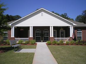 Toccoa apartment for rent - A white building with a bench in front of it.