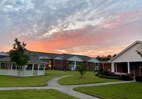 Trenton apartment for rent - A sunset view of a residential area with houses and a pathway.