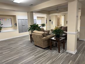 Jacksonville apartment for rent - A room with a couch, a table, and a potted plant.