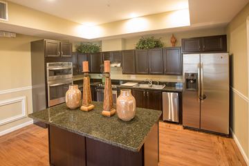 Gainsville apartment for rent - A kitchen with a granite countertop and stainless steel appliances.