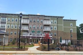Mableton apartment for rent - Apartment complex with a black fence in front.
