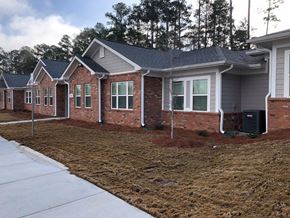 Winnsboro apartment for rent - A row of houses with a white fence in front.