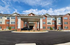 Aiken apartment for rent - A black car is parked in front of a building with a covered entrance.