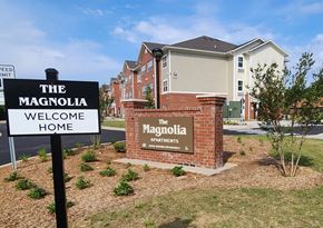 Aiken apartment for rent - The Magnolia Apartments sign in front of a building.