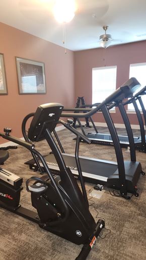 Aiken apartment for rent - A home gym with a treadmill, elliptical trainer, and a stationary bike.