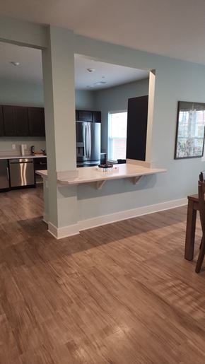 Aiken apartment for rent - A kitchen with a wooden floor and a white counter.