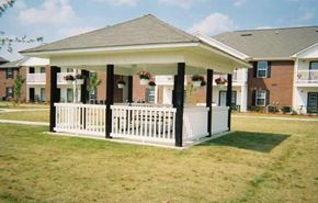 Thomson apartment for rent - A white porch with a black roof and pillars.