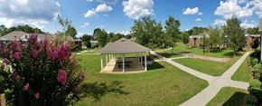 Fitzgerald apartment for rent - A gazebo is surrounded by a green lawn and a pathway.
