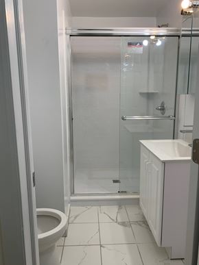 Caldwell apartment for rent - A white bathroom with a toilet, sink and shower.
