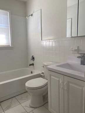 Atlantic Highlands apartment for rent - A white toilet sits next to a bathtub in a bathroom.