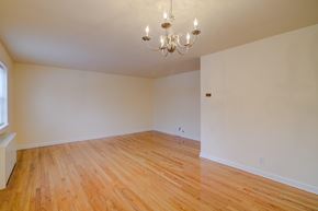 Fair Lawn apartment for rent - A room with wooden flooring and a chandelier.