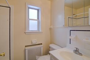 Fair Lawn apartment for rent - A bathroom with a white toilet, sink, and a window.