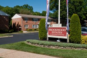 Atlantic Highlands apartment for rent - A sign for Brookwood Estates is in front of a brick building.